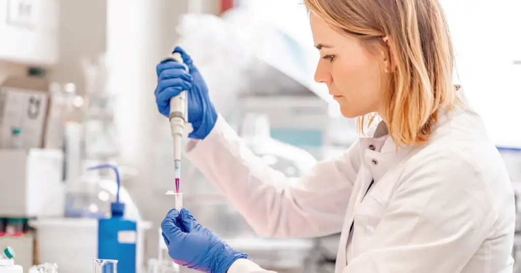 Doctor in a lab holding a syringe