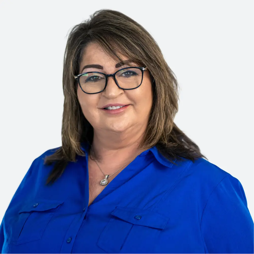a woman wearing glasses and a blue shirt