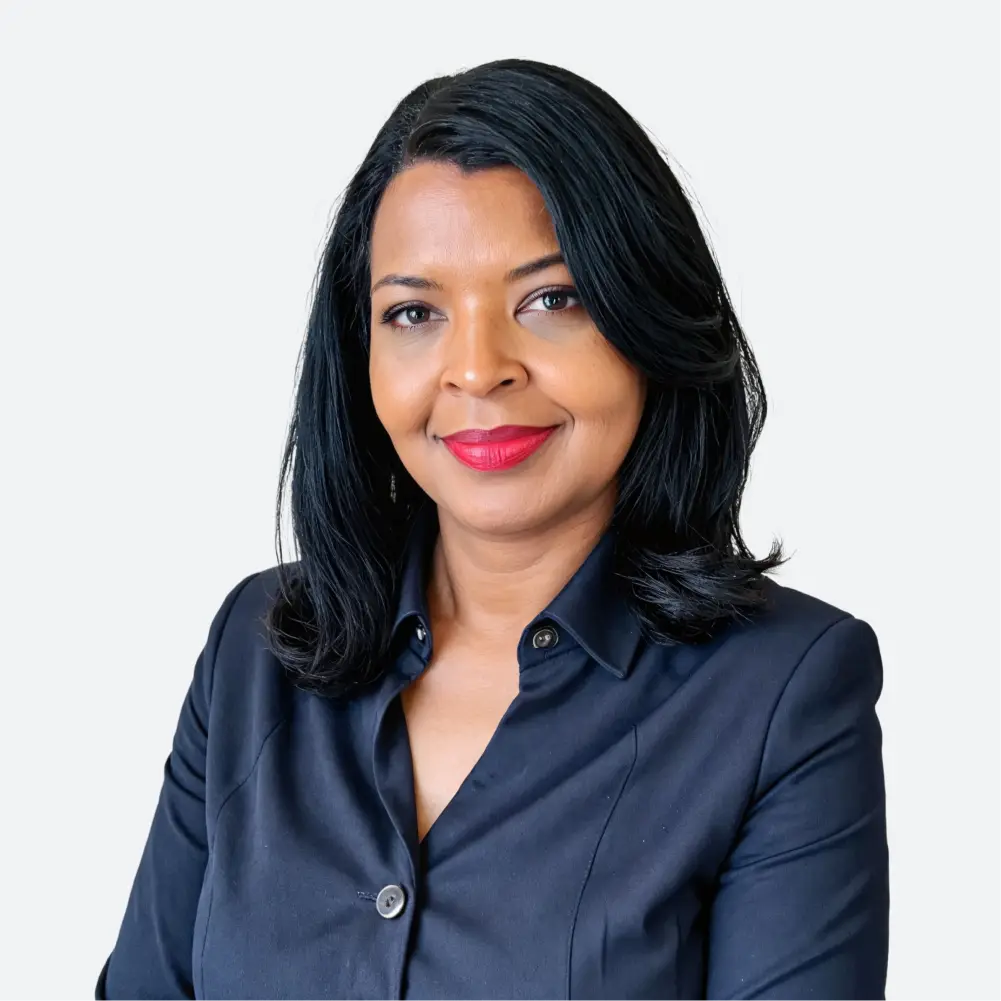 a woman with dark hair wearing a dark blue shirt