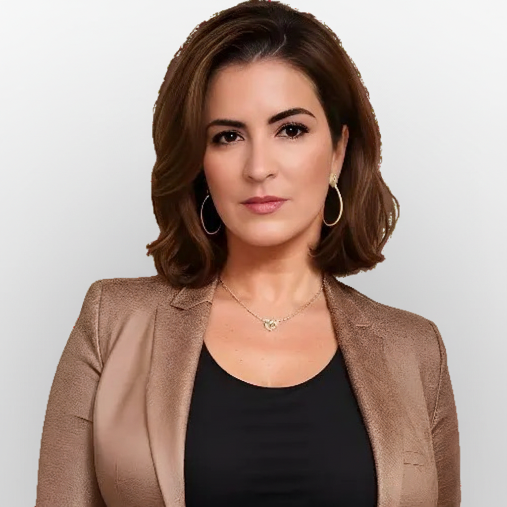 Professional headshot of a woman with shoulder-length brown hair, wearing a tan blazer over a black top, gold hoop earrings, and a neutral expression against a dark background.