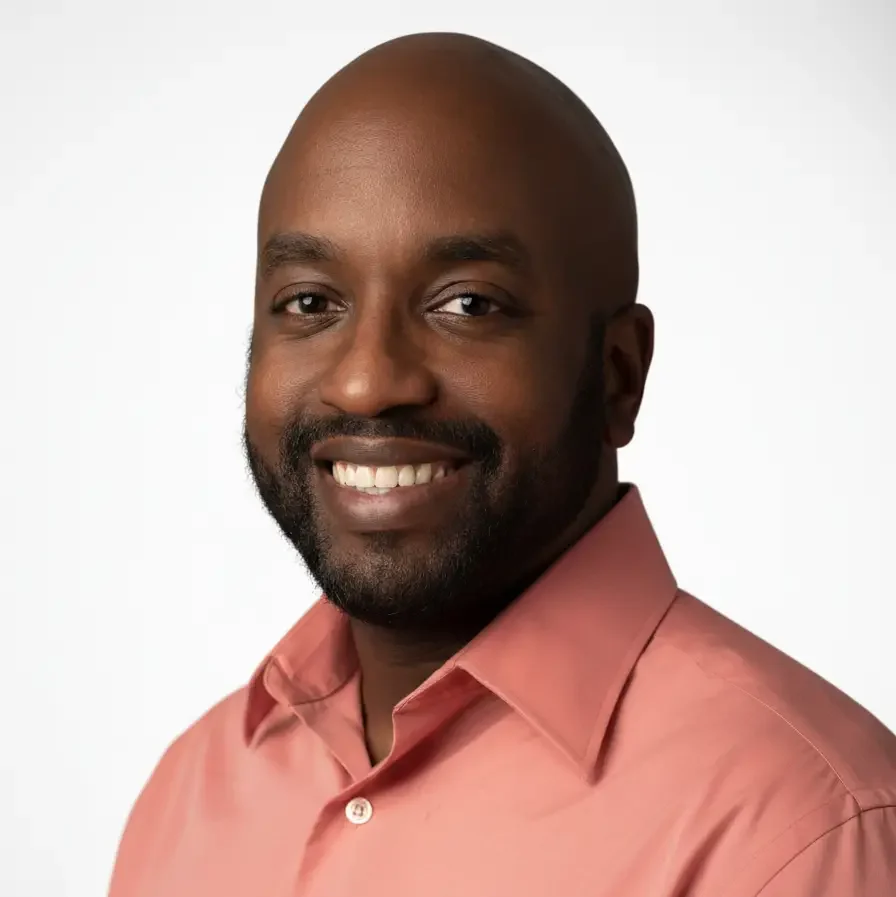 Professional headshot of the executive director of Haven Detox Oklahoma, smiling and wearing a coral button-down shirt, representing leadership at an Oklahoma drug and alcohol detox treatment center.